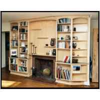 Maple fireplace surround with bookshelves and floating display shelves, features low voltage halogen recessed lighting