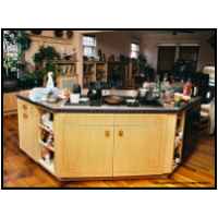 Kitchen, bookcases, mantle, and table are hard white maple with cherry string inlay in a greco Celtic pattern. Table top and mantle face are inlaid with an antique veneer inlay from the 1920's. Pulls are proprietary 'Celtic' solid wood laminations with an end grain face.