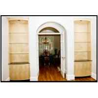 Semi-elliptical faced foyer cabinets back up to retro dining room builtins.