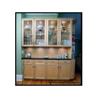 Hard white maple, flat panel in frame, concealed hinges. Curved face corner makes transition from butlers pantry to refrigerator.
